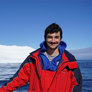 A smiling man in a red jacket